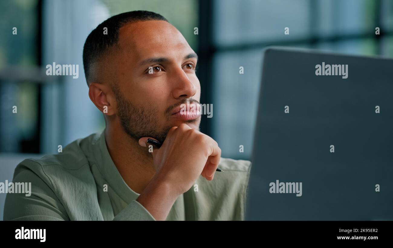 Primo piano pensivo africano pensoso Latina uomo manager scrittore giornalista esperto imprenditore tenendo matita pensare pensiero idea pensare pianificazione Foto Stock