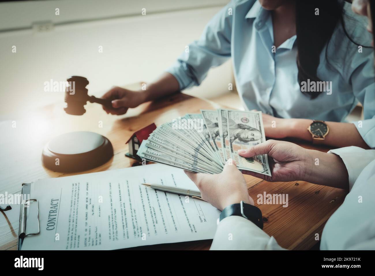 Concetti legali e contratti si concentra sulle donne in possesso di dollari con documenti contrattuali e pagamenti di acquisto casa. Foto Stock