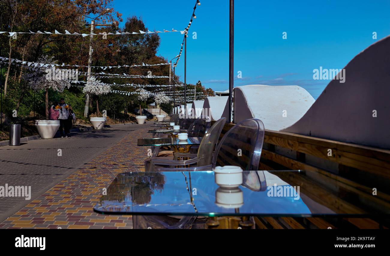 Modello di tavoli di vetro trasparente di un ristorante sulla spiaggia in autunno Odessa Ucraina Foto Stock