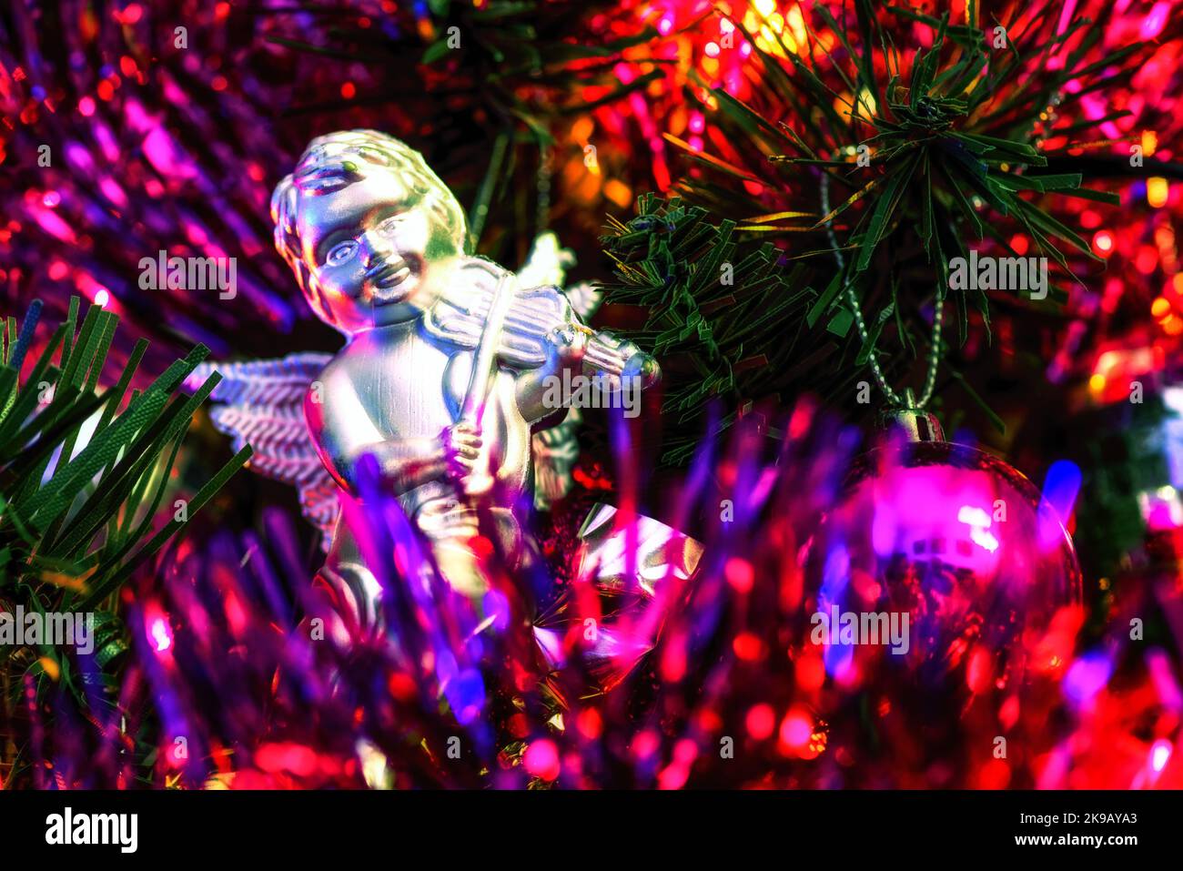 Palla e carino angelo giocattolo con violino appeso e decorare un albero di Natale. Foto Stock