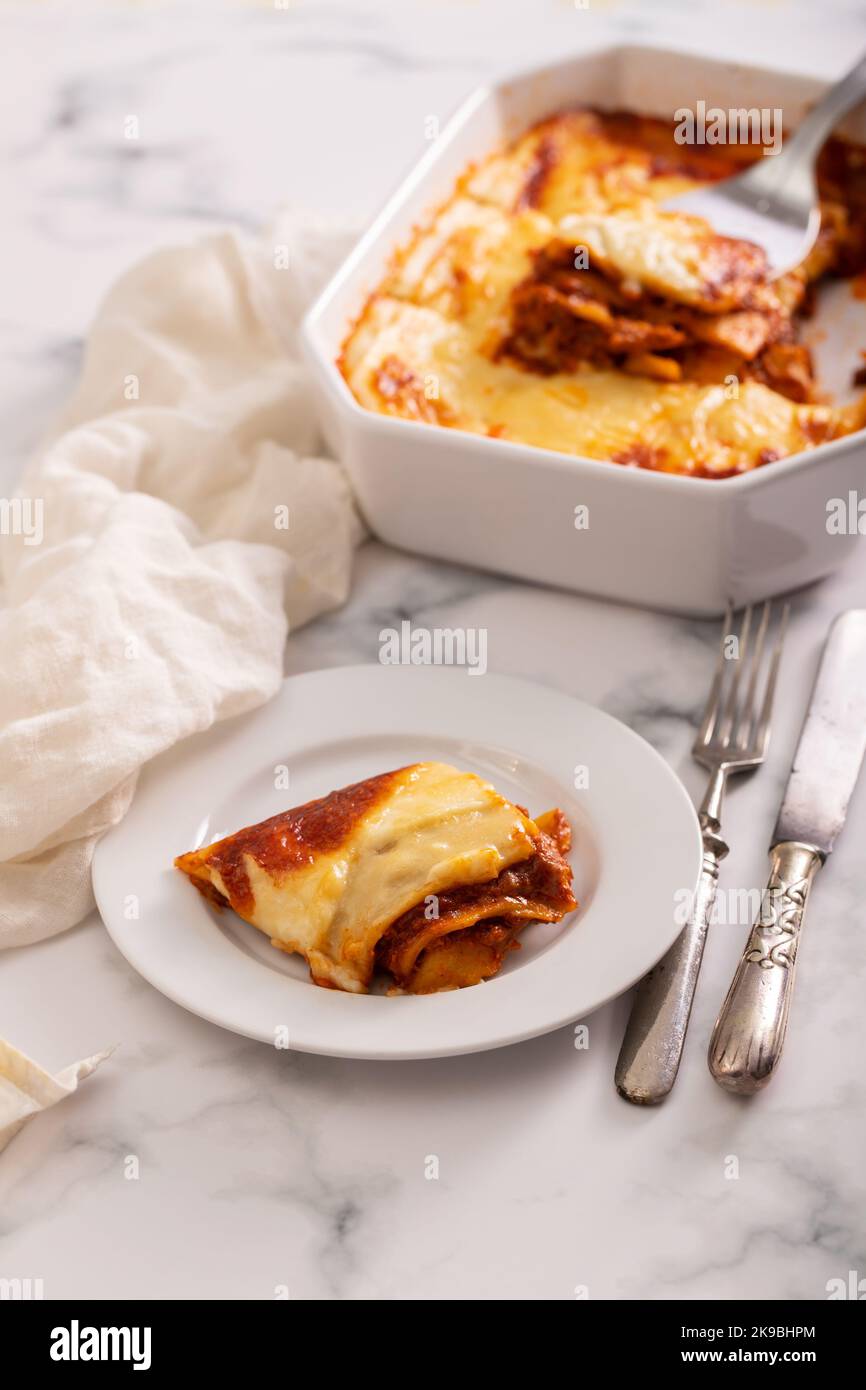 Lasagne fresche con salsa di carne e pomodoro cotte al forno in un piatto di ceramica. Foto Stock