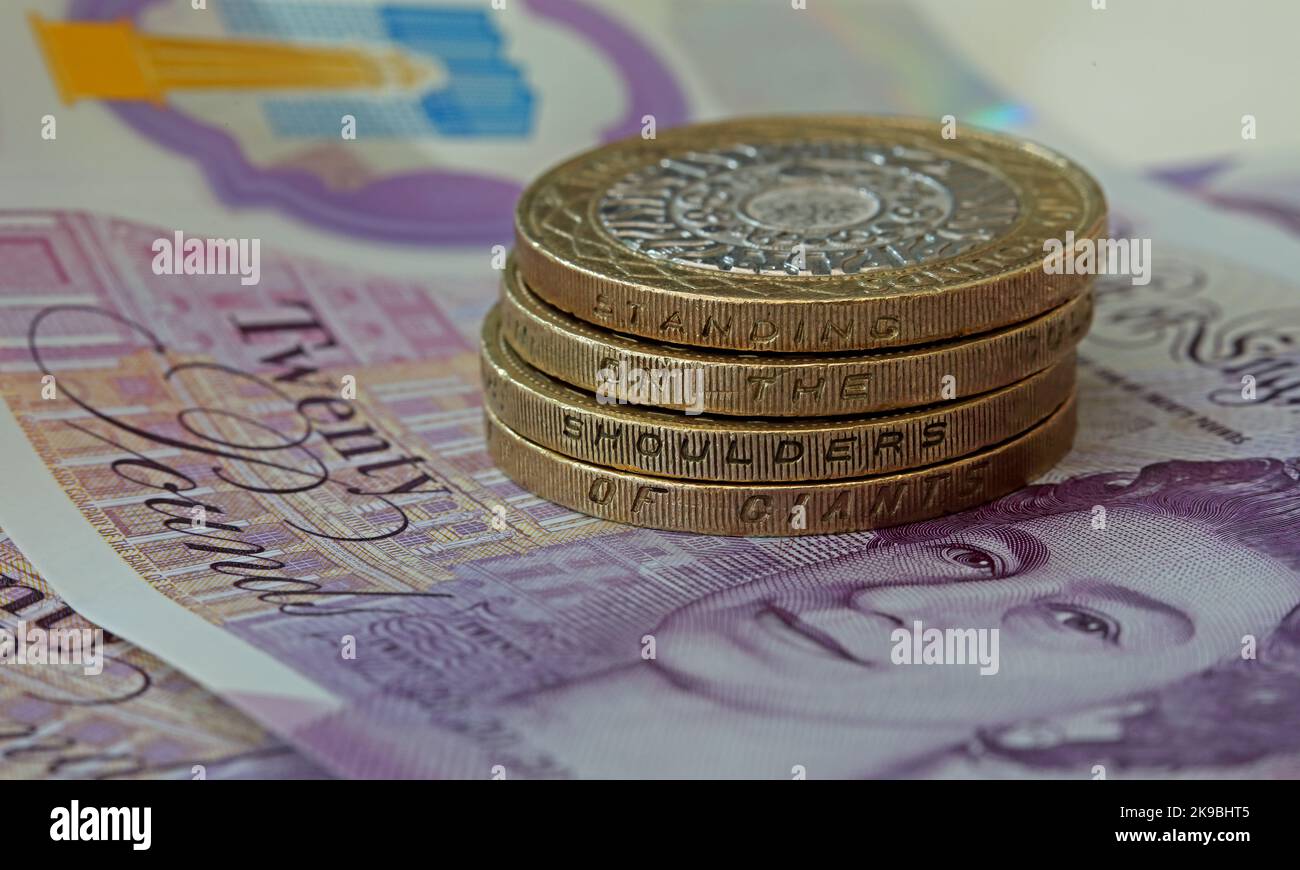 Bank of England, banconote in sterline, con due monete da lire che riportano l'iscrizione "in piedi sulle spalle dei giganti". Monete e banconote in contanti Foto Stock