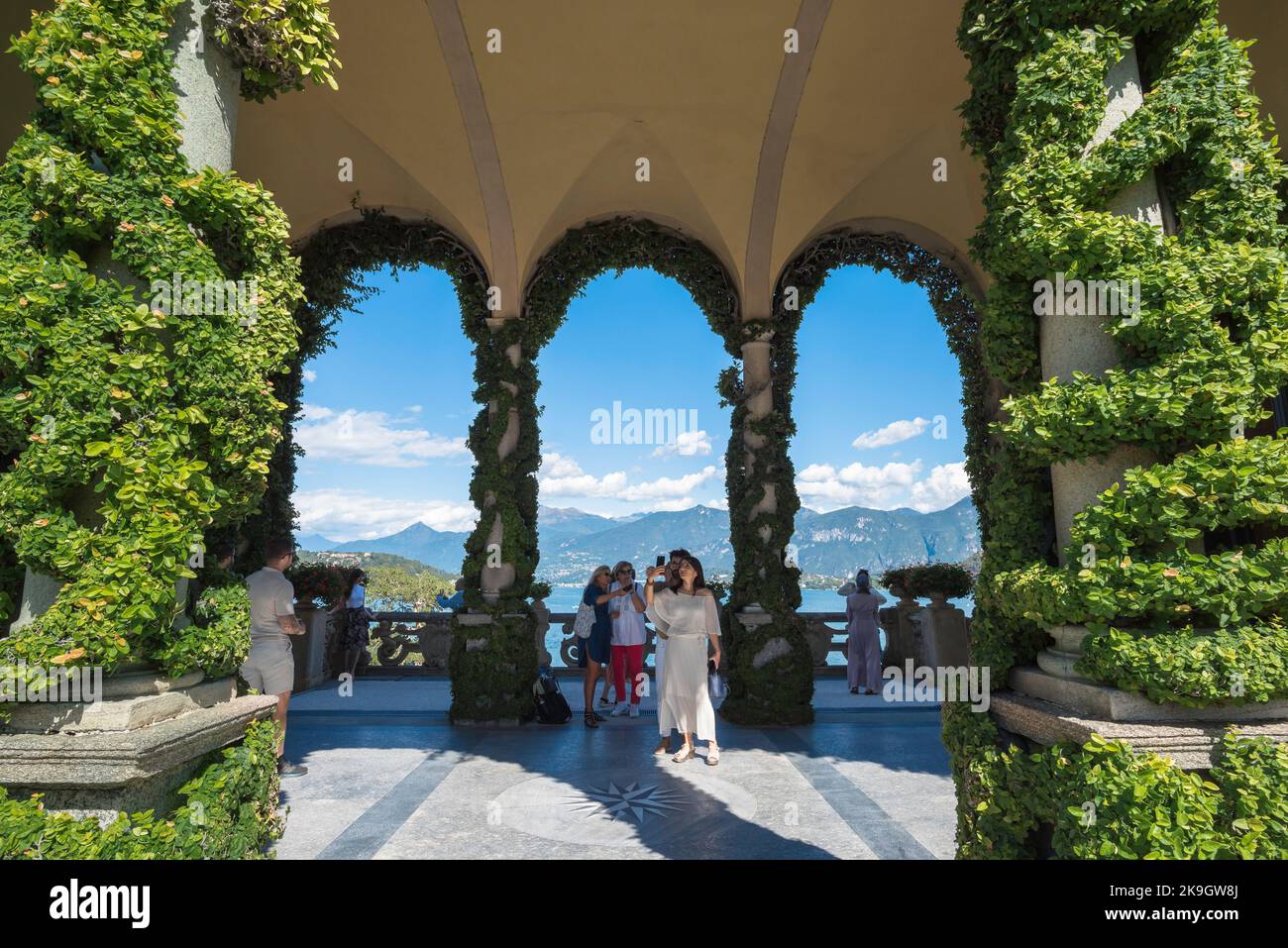 Villa del Balbianello, vista in estate di una turista femminile scattando una foto all'interno della loggia rinascimentale della Villa del Balbianello, Lenno Italia Foto Stock