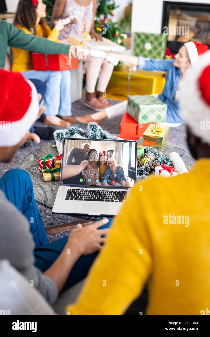 Diversi gruppi di amici che hanno videochiamate natalizie con persone diverse Foto Stock
