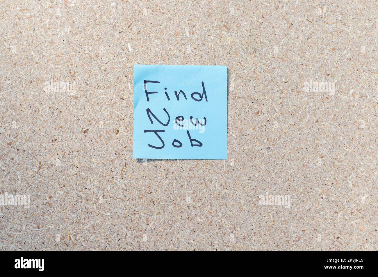 Frase manoscritta di trova nuovo lavoro su una nota adesiva blu Foto Stock
