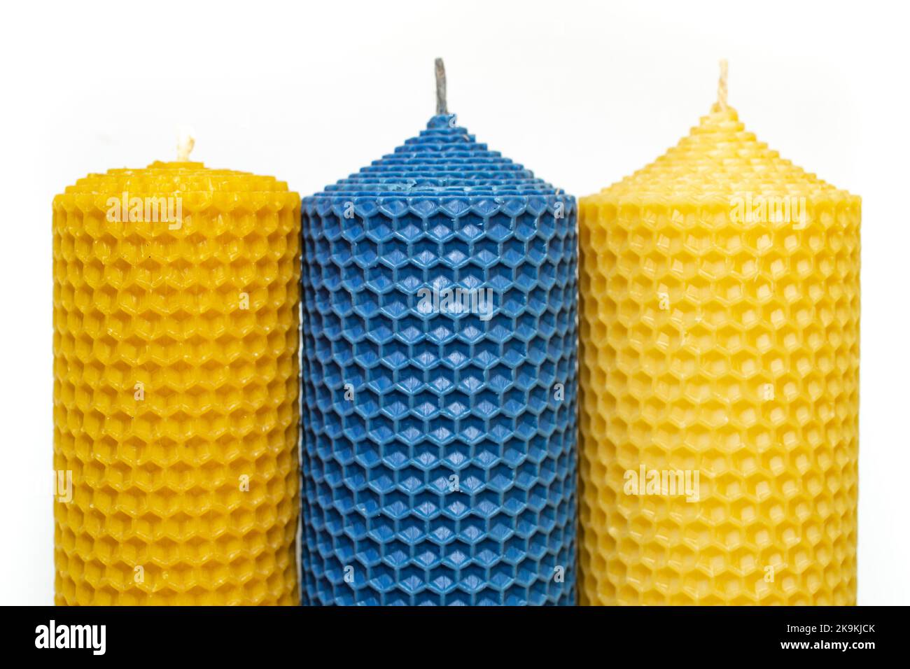 candele gialle e blu con motivo a nido d'ape, primo piano Foto Stock