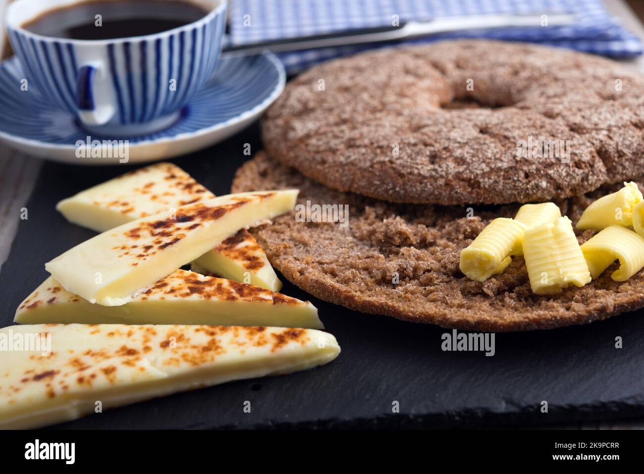 Prima colazione finlandese con mini formaggi contadini Leipajuusto, burro, pane buco Reikaleipa, e una tazza di caffè Foto Stock