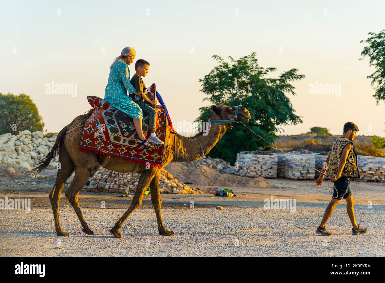 10.10.2022 Side, Turchia. Due turisti - madre caucasica e suo figlio - seduti su una sella su un cammello. Attrazione turistica. Foto di alta qualità Foto Stock