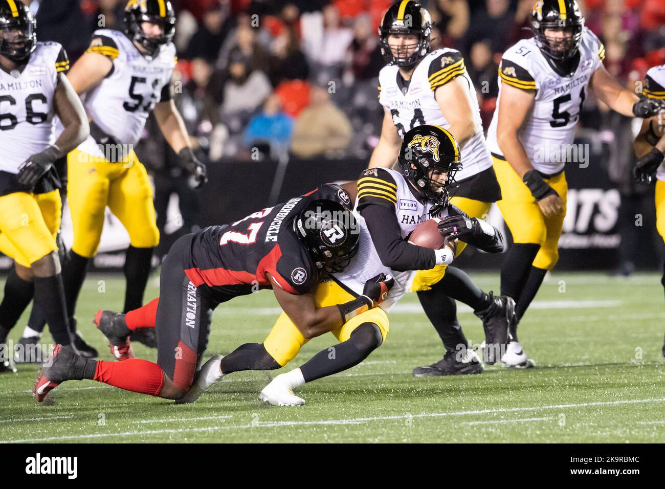 29 ottobre 2022: Il quartback Hamilton Tiger-Cats Dane Evans (9) viene affrontato dal lineman difensivo di Ottawa Redblacks tre Hornbuckle (97) durante il gioco CFL tra Hamilton Tiger-Cats e Ottawa Redblacks tenutosi al TD Place Stadium di Ottawa, Canada. Daniel Lea/CSM Credit: CAL Sport Media/Alamy Live News Foto Stock