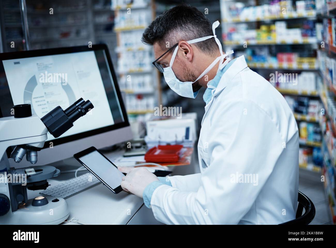 Sostenere la ricerca farmaceutica con la tecnologia più recente. Un uomo maturo che utilizza un tablet digitale mentre conduce la ricerca farmaceutica. Foto Stock