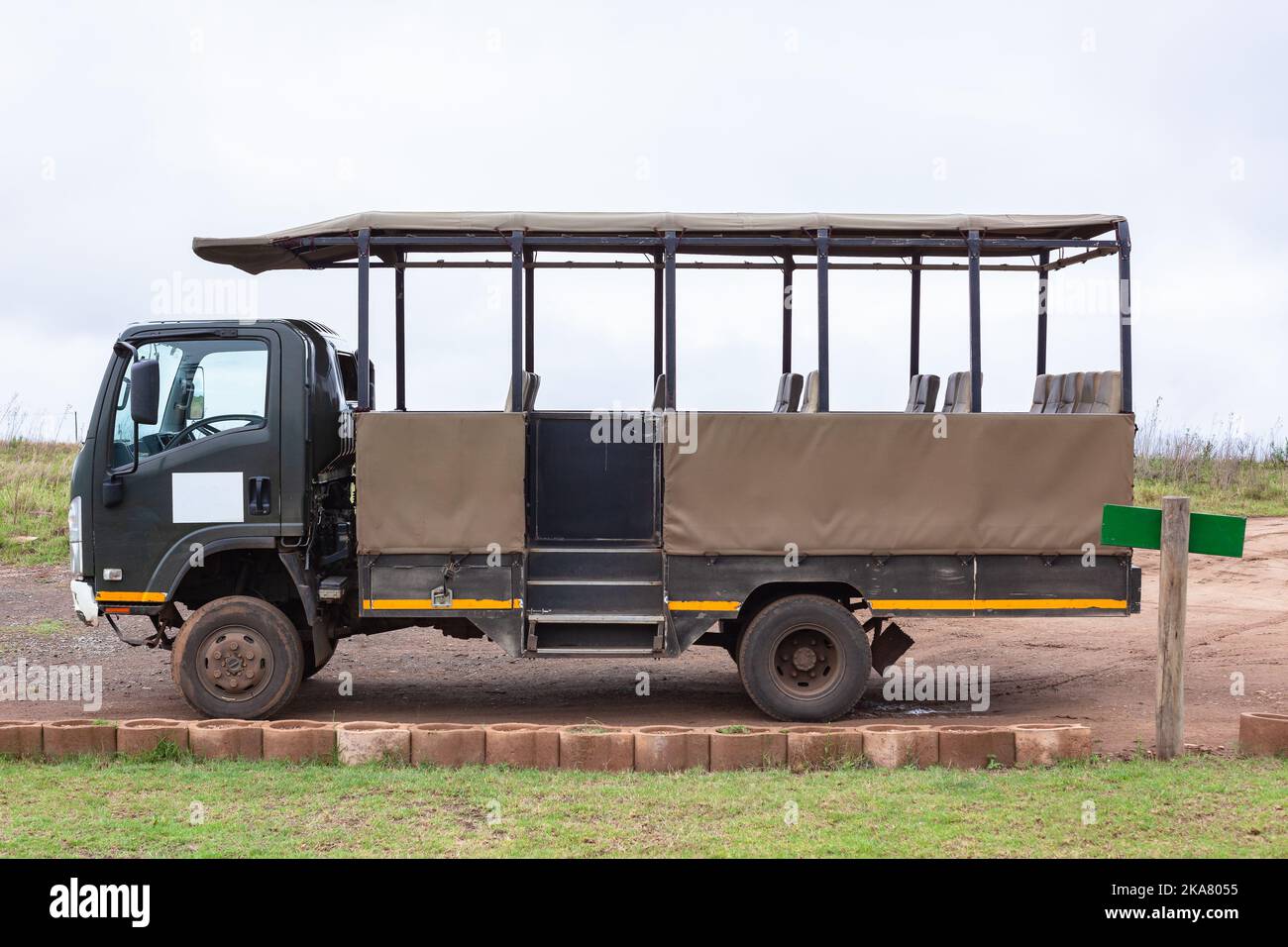 Safari veicolo camion con posti a sedere aperti per più di una dozzina di persone parcheggiate vuoto utilizzato per la guida di animali per vedere la fauna selvatica Foto Stock