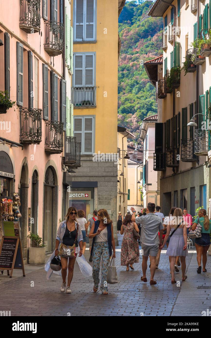 Shopping in Italia, vista in estate di persone che camminano in una strada panoramica dello shopping nel centro storico della città di Como, Lago di Como, Italia, Lambardy Foto Stock