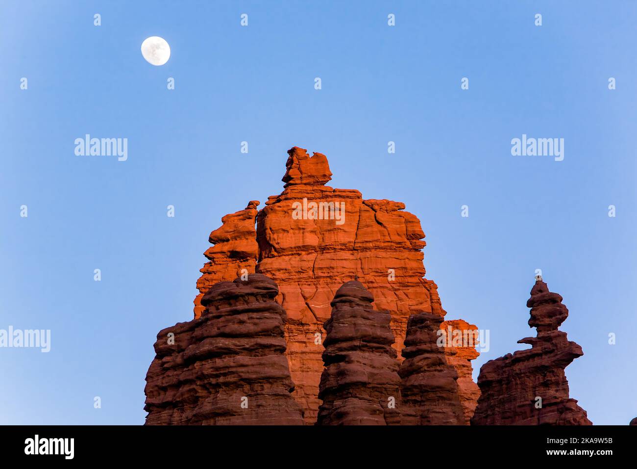La luna che sorge sopra il Cottontail & Ancient Art nelle Fisher Towers, erose formazioni rocciose di pietra arenaria di Cutler vicino a Moab, Utah. Foto Stock