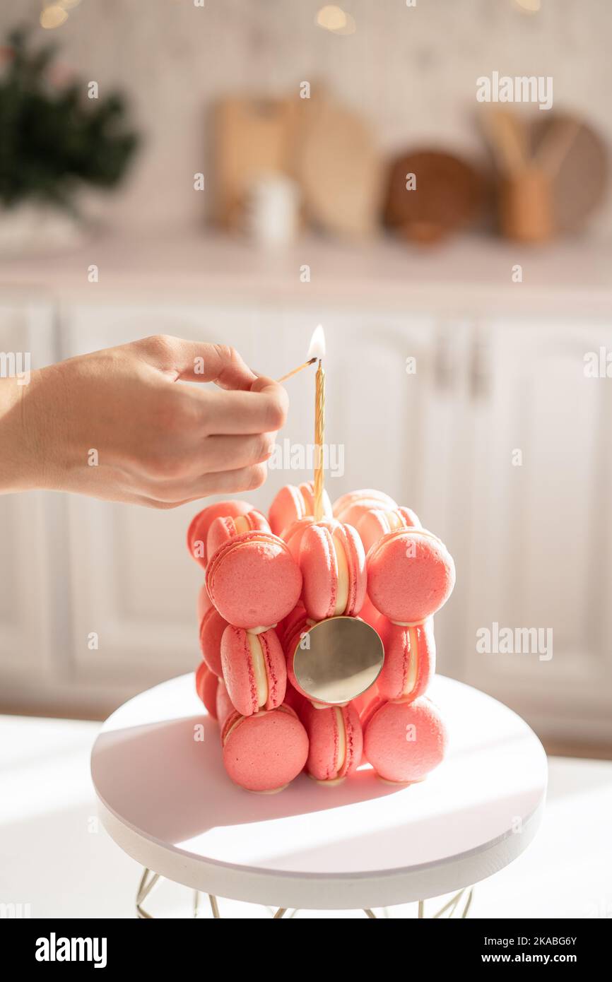 Accendere una candela su una torta di macaron Foto Stock