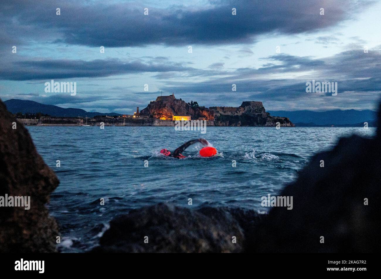 Un nuotatore di fronte alla Fortezza Vecchia, Corfù Città Greee Foto Stock