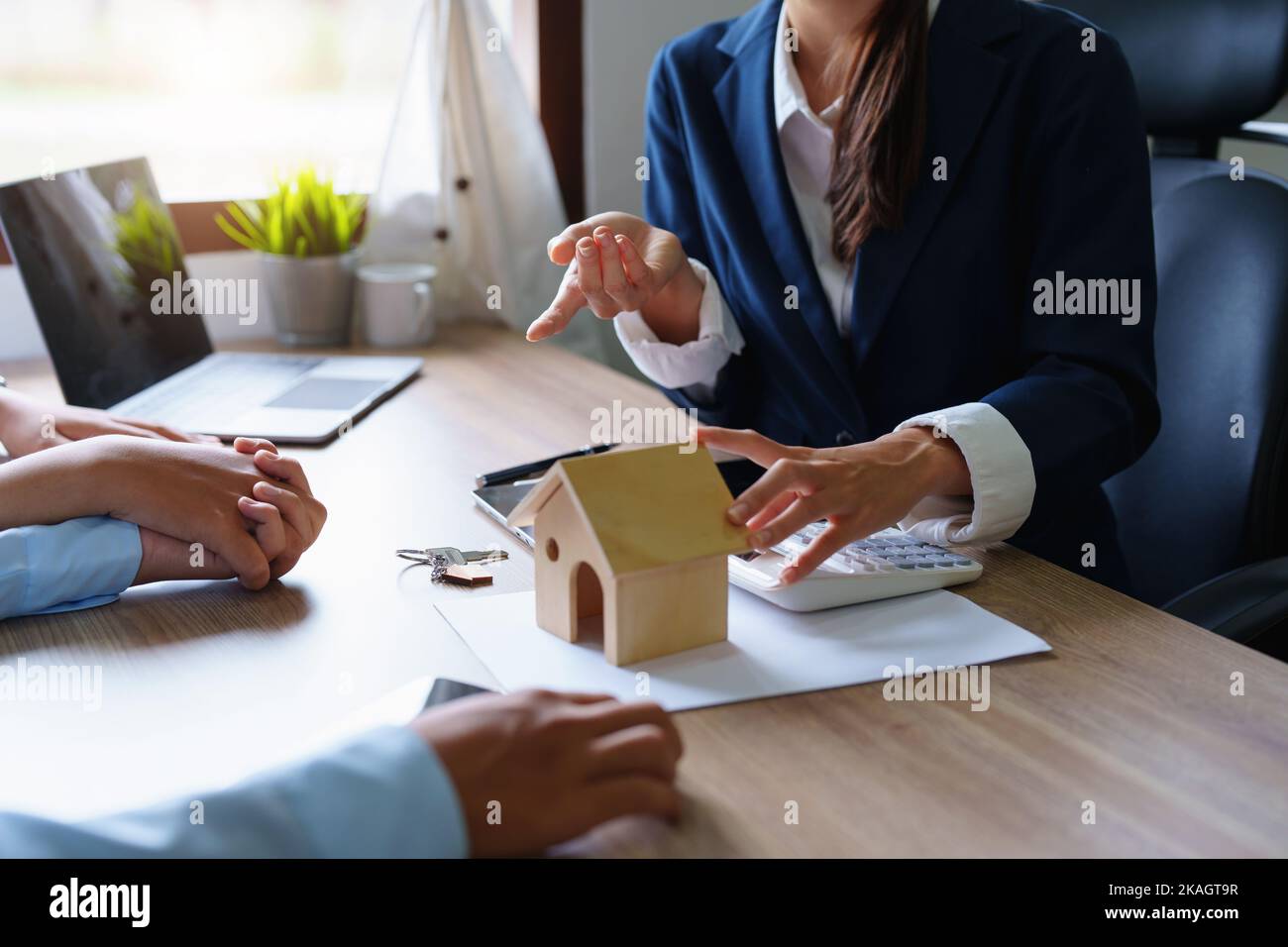 Ritratto di un agente immobiliare o funzionario bancario, il reparto prestiti cita l'interesse sul prestito al cliente per valutare il rischio di Foto Stock