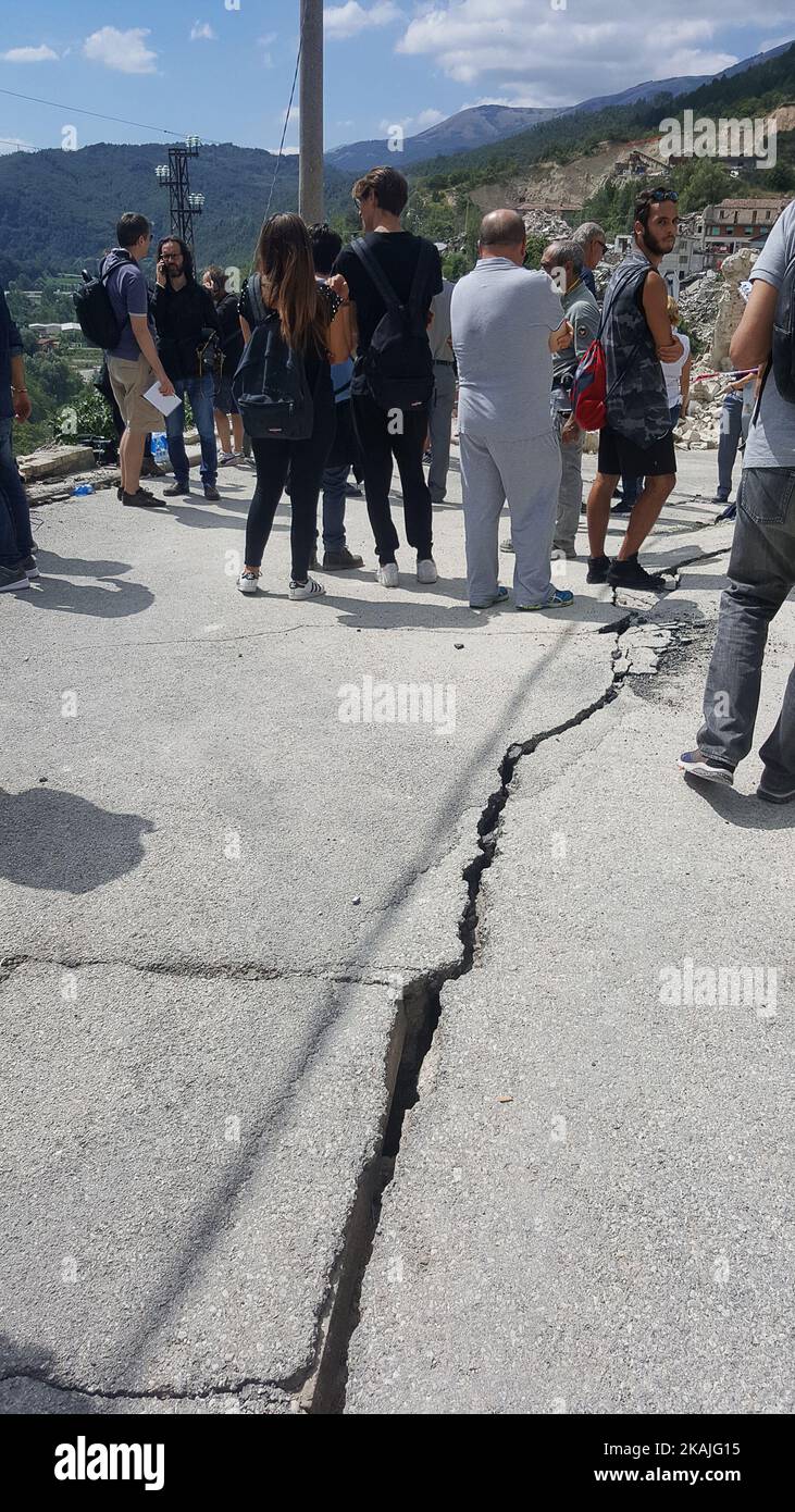 La gente cammina a Pescara del Tronto, Italia, il 24 agosto 2016. Un potente terremoto pre-alba ha devastato i villaggi montani dell'Italia centrale il 24 agosto 2016, lasciando almeno 159 persone morte e decine di feriti, intrappolati o dispersi. (Foto di Federica Roselli/NurPhoto) *** Please use Credit from Credit Field *** Foto Stock