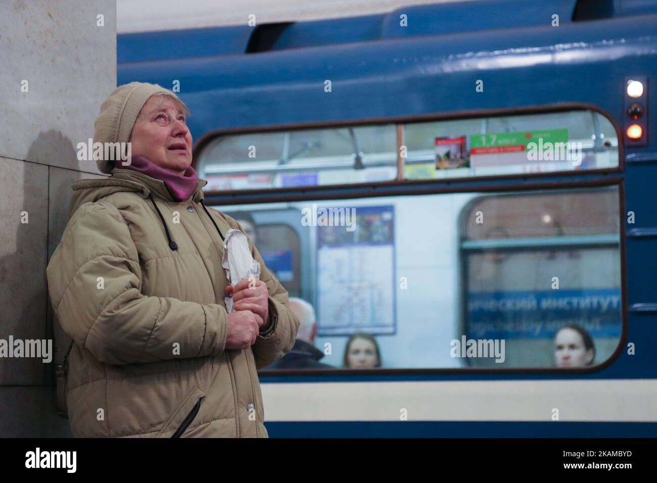 Una donna reagisce mettendo fiori in onore delle vittime dello scoppio del 3 aprile sulla piattaforma della stazione della metropolitana dell'Istituto tecnologico a San Pietroburgo il 4 aprile 2017. . La polizia russa continua le indagini dopo che 14 persone sono state uccise e decine di feriti a San Pietroburgo a seguito di esplosioni tra due stazioni della metropolitana della città. Secondo quanto riferito, il sospetto è un nativo del Kirghizistan, chiamato Akbarzhon Jalilov, che ha ottenuto la cittadinanza russa, secondo il servizio di sicurezza del paese dell'Asia centrale. Le autorità di San Pietroburgo hanno dichiarato tre giorni di lutto. (Foto di Ig Foto Stock