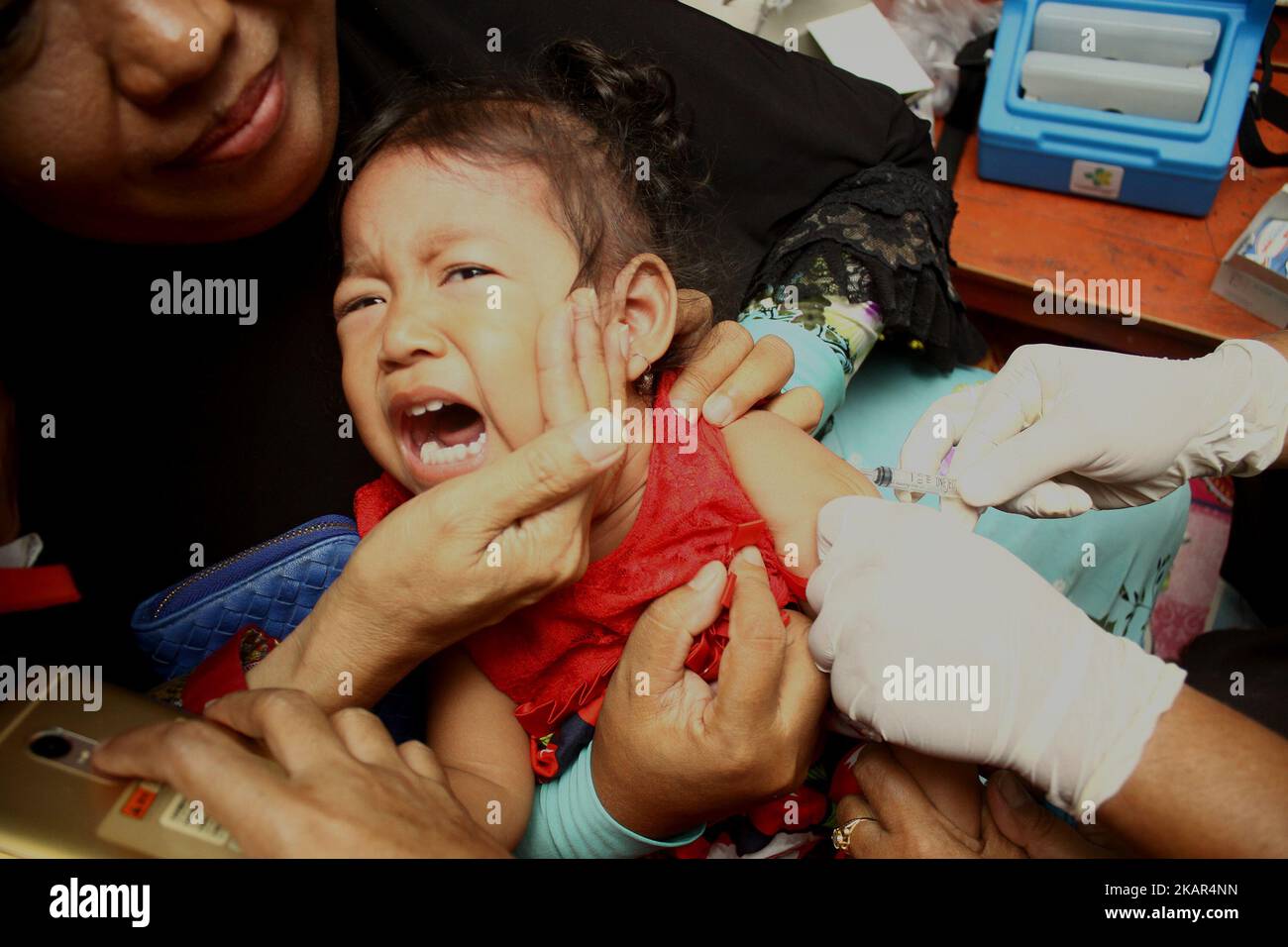 Gli agenti sanitari hanno iniettato il vaccino contro il morbillo Rubella ai bambini in un posto di servizio sanitario integrato a Wanasari Village, West Java, il 8 settembre 2017. Il governo indonesiano si rivolge a un minimo del 95% o a 34.964.384 bambini in tutta l'Indonesia di età compresa tra 9 mesi e 15 anni, ottenendo il vaccino contro la RM, attraverso il programma della campagna di immunizzazione, che inizia da agosto a settembre 2017 e agosto-settembre 2018. La campagna di immunizzazione contro la RM è la realizzazione di un programma governativo per eliminare il morbillo e la rosolia in Indonesia entro il 2020. (Foto di Aditya Irawan/NurPhoto) Foto Stock