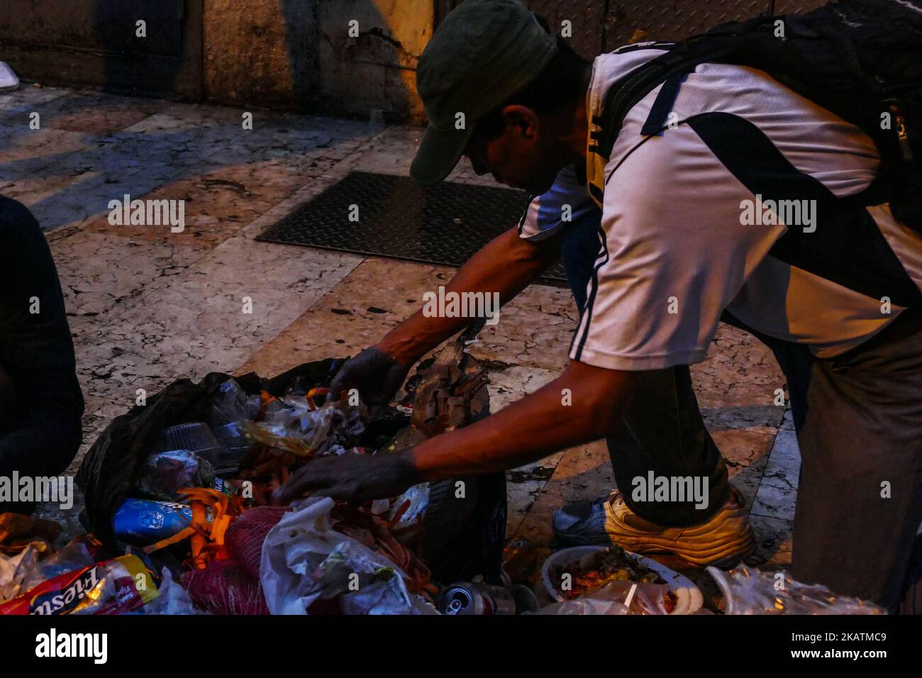 La gente guarda nella spazzatura in cerca di cibo a Caracas, Venezuela, il 30 novembre 2017 a causa della grave crisi economica che attraversa il paese petrolifero dopo il crollo del prezzo del barile di petrolio e da politiche statali che non aiutano a stabilizzare l'economia. (Foto di Roman Camacho/NurPhoto) Foto Stock