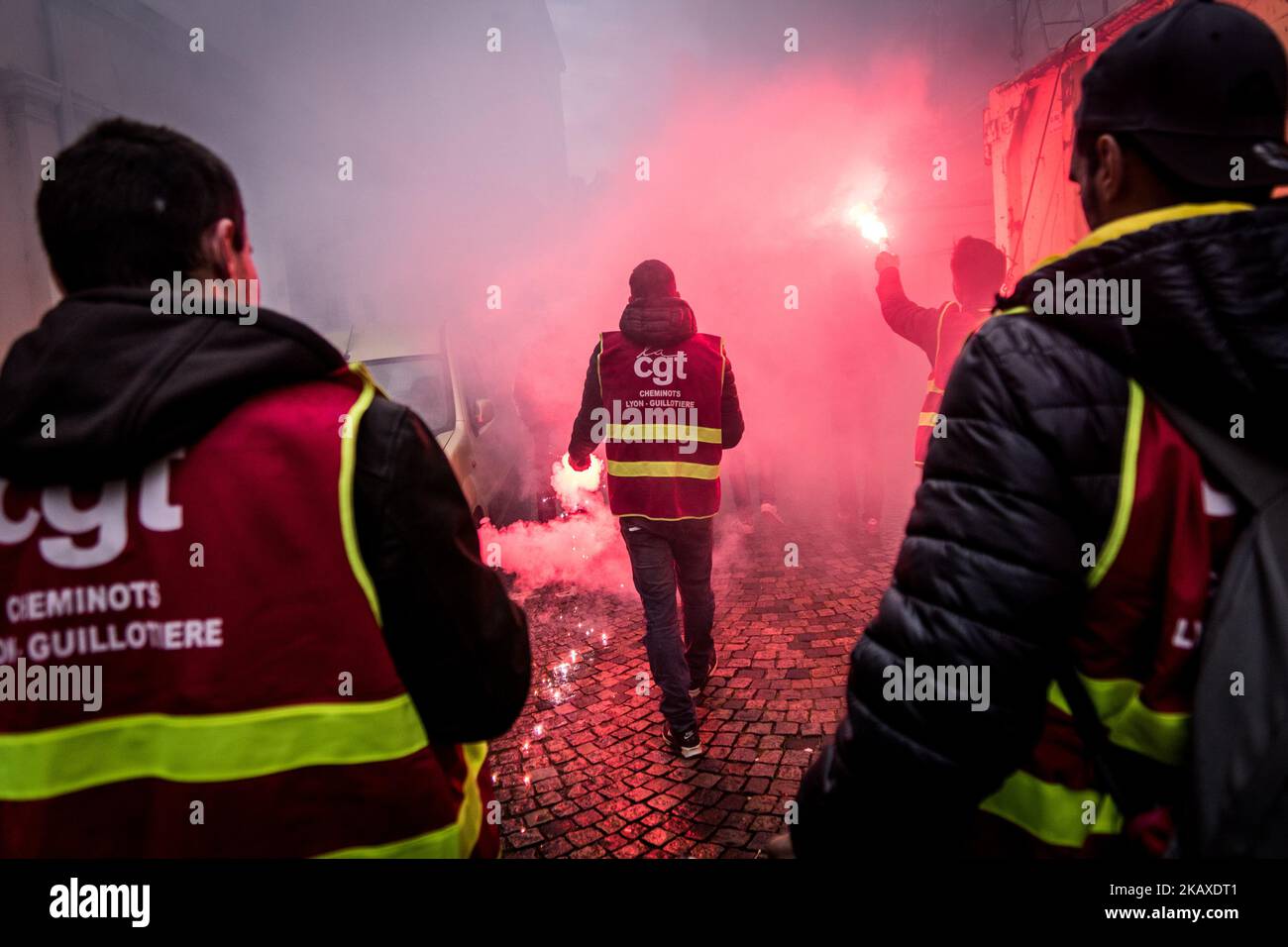 I manifestanti dei dipendenti della SNCF tengono un banner e hanno acceso i faretti durante una protesta dei lavoratori ferroviari e di altri sindacati a Lione, in Francia, il 4 aprile 2018. Treni e aerei sono stati cancellati in tutta la Francia mentre i sindacati hanno spinto in avanti con proteste contro il presidente Emmanuel Macrons piani per eliminare i benefici da alcuni lavoratori statali. (Foto di Nicolas Liponne/NurPhoto) Foto Stock