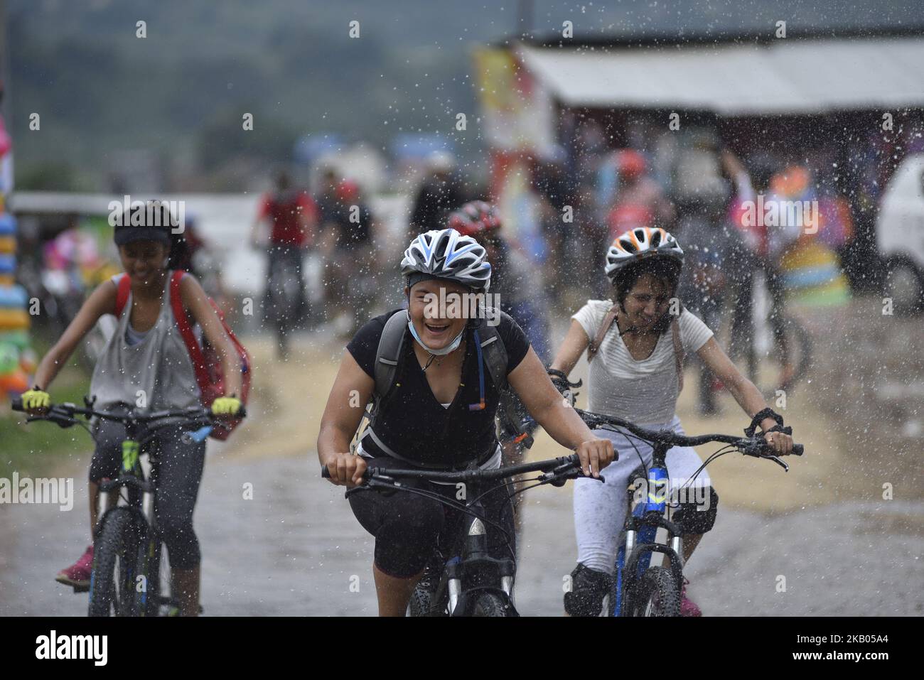 I ciclisti godono come gocce d'acqua spruzza dalla gente durante Kathmandu Kora Cycling 2018 CORSA per una causa a Chobhar, Kathmandu, Nepal il sabato 21 luglio 2018. Piloti provenienti dal Nepal e da diversi paesi hanno partecipato a una sfida di 50 km, 75 km e 100 km intorno Kathmandu Valley sulla sua ottava edizione di KATHMANDU KORA. (Foto di Narayan Maharjan/NurPhoto) Foto Stock