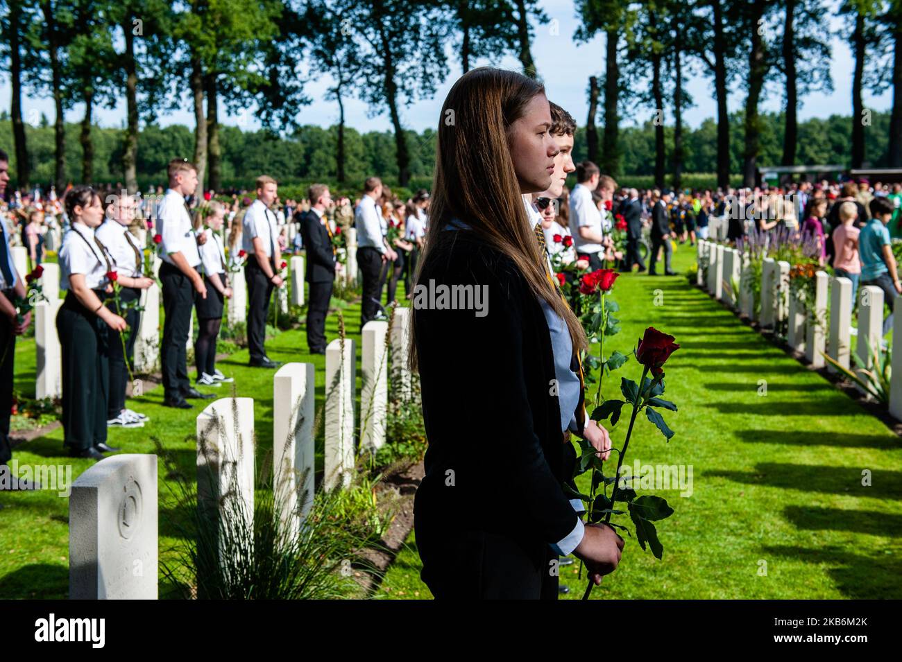Settembre 22nd, Oosterbeek. Nel cimitero di guerra di Arnhem Oosterbeek, sono sepolti più di 1750 soldati alleati. Nell'ambito delle commemorazioni del 75th° anniversario dell'operazione Market Garden, si è svolto un servizio commemorativo alla presenza di veterani, loro parenti e migliaia di persone. Tradizionalmente i 'figli di fiori' del comune di Remkum depongono i fiori alle lapidi, quest'anno sono stati anche bambini di altri paesi che posavano i fiori alle lapidi. Su ogni tomba è posto un arco di pietra bianca, sul campo d'onore è una "Croce del sacrificio" fatta di pietra Portland, sulla quale è collocato un bronzo Foto Stock