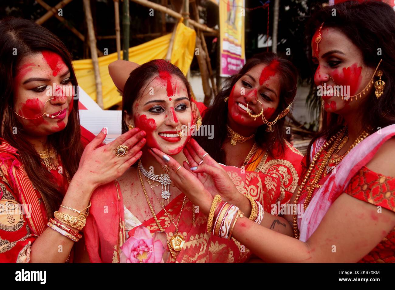 Un devoto indù indiano sorride mentre è cosparsa di polvere di vermillion come parte di un rituale di 'Sindhoor Khelaa' in occasione del festival Dushhera-Vijaya Dashami l'ultimo giorno di Durga Puja a Kolkata il 08,2019 ottobre. Il Sindhoor Khela è un rituale eseguito da donne sposate per augurarsi una lunga vita coniugale. (Foto di Debajyoti Chakraborty/NurPhoto) Foto Stock