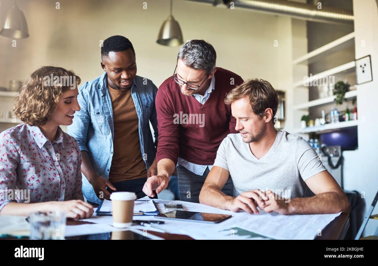 Insieme risolviamo i problemi più velocemente. Un team creativo che ha una sessione di brainstorming nella sala riunioni. Foto Stock