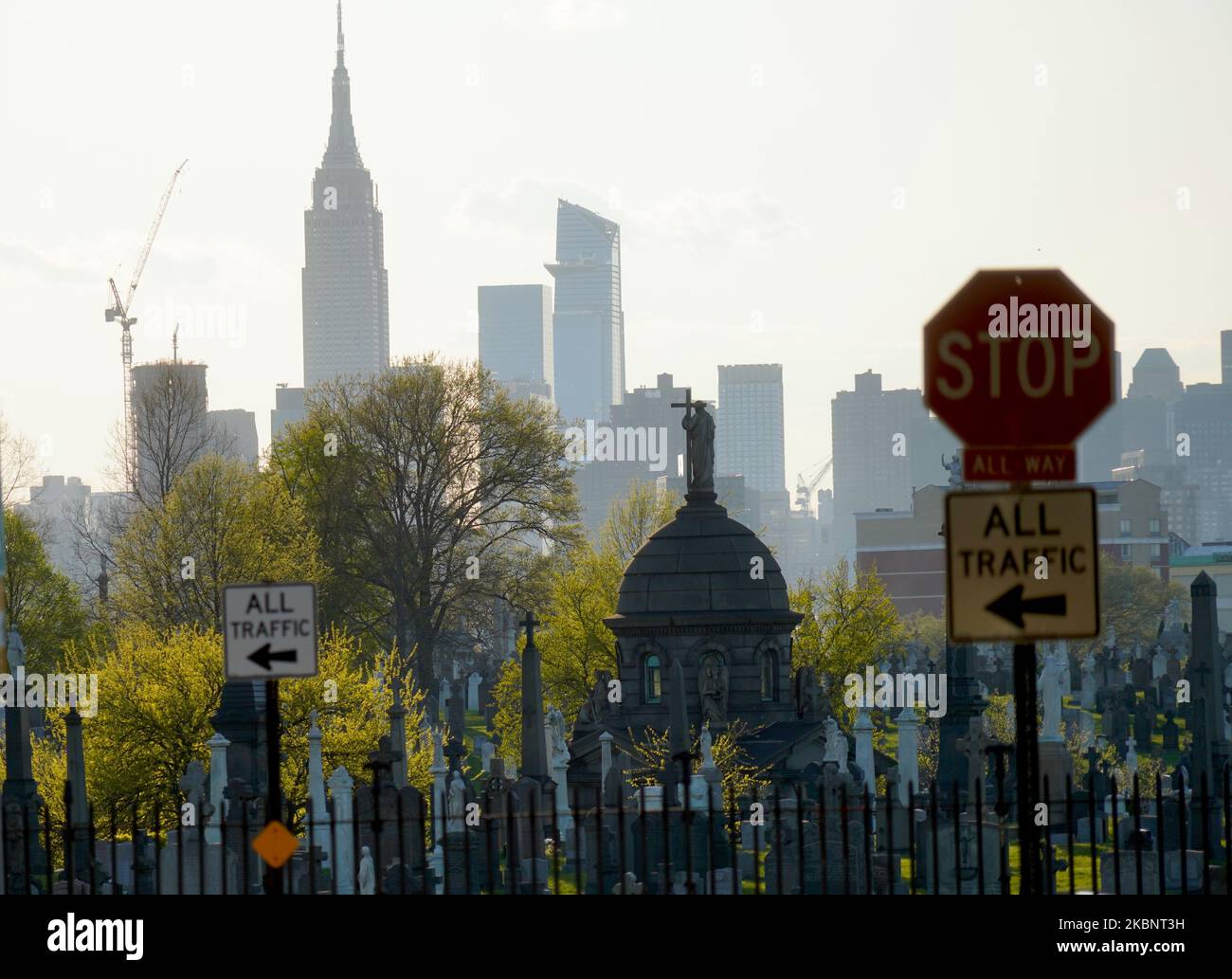 Le lapidi sono viste in un cimitero di New York City sullo sfondo dei grattacieli di Manhattan, Stati Uniti il 13 maggio 2020. (Foto di Selcuk Acar/NurPhoto) Foto Stock
