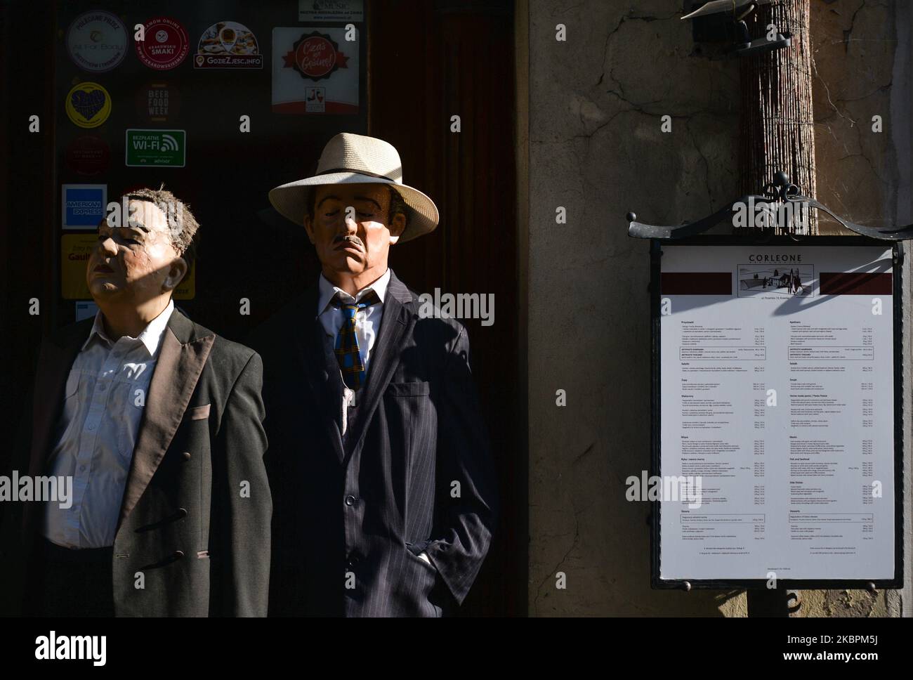 Statue di cera di Vito Corleone e Don Fanucci, due personaggi immaginari del romanzo di Mario Puzo del 1969 il Padrino, visto al di fuori del ristorante italiano 'Corleone' nel centro storico di Cracovia. Per diversi giorni, gli hotel, i ristoranti e le attrazioni turistiche di Cracovia si adattano ai regolamenti del coronavirus e ritornano all'attività. Cracovia e le altre città polacche che partecipano alla campagna #CityWillWait non aspettano più e sono pronte per la ricezione sicura dei turisti di ritorno. L'azione continuerà sotto gli slogan #CityIsReady e #We'reReady. Martedì 2 giugno 2020 a Cracovia, Polonia. (Foto di Artur Foto Stock
