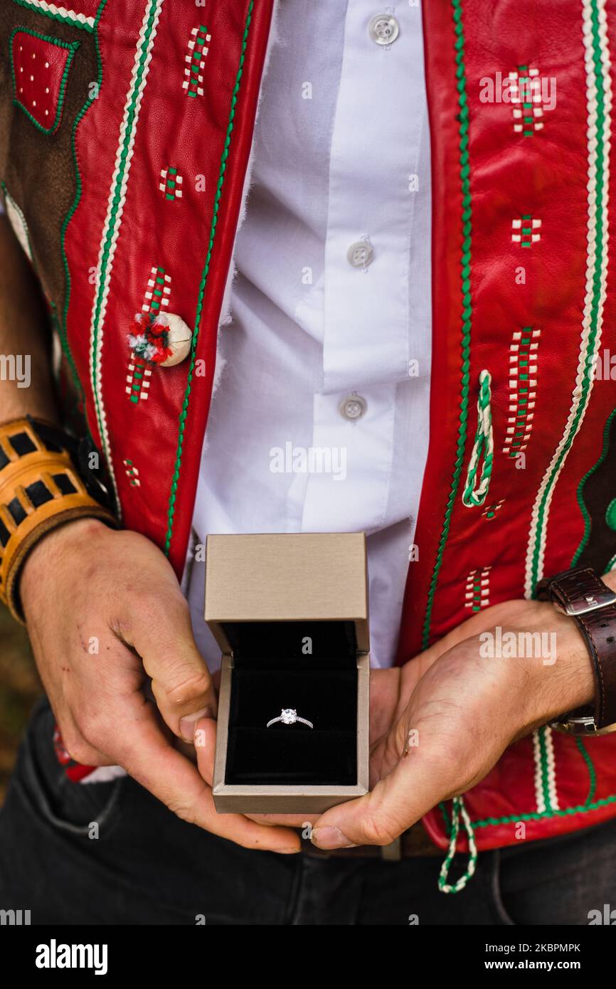 Ritratto di un uomo vestito con un tradizionale costume popolare slovacco che regge una scatola con un anello di aggancio in oro bianco Foto Stock