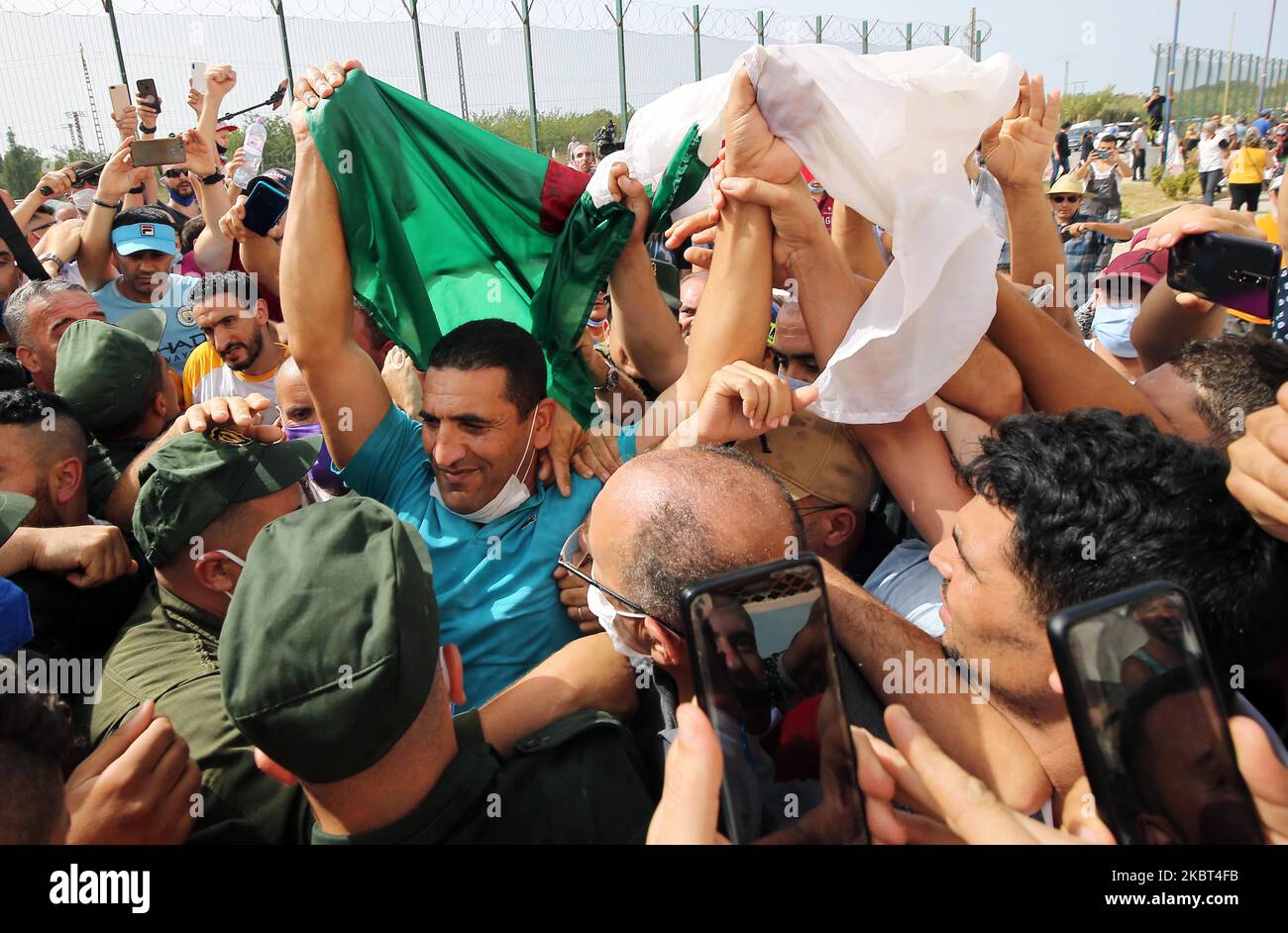 Karim Tabbou (C, camicia blu), la figura iconica del movimento popolare anti-regime di Hirak, è circondato da tifosi acclamati dopo il suo rilascio dalla prigione di Kolea, 56 chilometri ad ovest di Algeri, Algeria, 02 luglio 2020. Il 02 luglio scorso le autorità giudiziarie algerine hanno deciso di liberare Tabbou, imprigionato dal 26 settembre 2019, e altri tre noti oppositori del regime dalla prigione. Karim Tabbou era stato condannato in appello il 24 marzo, ad un anno di carcere per 'minare l'integrità del territorio nazionale (Foto di Billal Bensalem/NurPhoto) Foto Stock