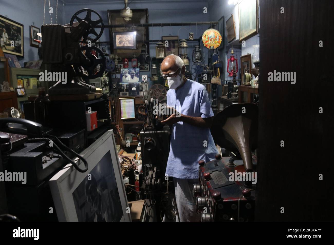 Un collezionista Shri Sushi Kumar Chatterjee uomo di ,95 anni mostra un antico fermo macchina fotografica e cine, proiettori nella sua residenza durante la Giornata Mondiale della Fotografia a Kolkata, India il 19 agosto 2020. (Foto di Debajyoti Chakraborty/NurPhoto) Foto Stock