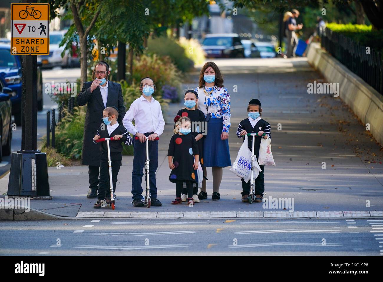 Una famiglia ebraica gode del clima autunnale a Borough Park, che serve i membri delle comunità ebraiche ortodosse della città il 06 ottobre 2020 a New York City. Borough Park è uno dei numerosi quartieri di Brooklyn che stanno assistendo a un picco nel numero di casi COVID-19, in quanto New York City continua a scendere a circa l'1% del tasso di infezione. Molti dei quartieri che hanno subito un picco nei casi sono quartieri ortodossi ebrei che hanno avuto problemi con le autorità nel limitare i grandi funerali e matrimoni. Il sindaco di New York Bill de Blasio ha annunciato piani per chiudere le none Foto Stock