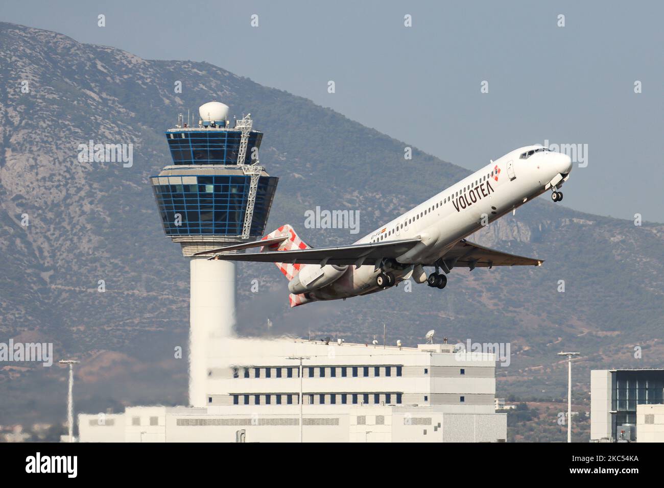 Velivolo Volotea Airlines Boeing 717 che declina come visto in partenza dall'aeroporto internazionale di Atene ATH di fronte al terminal e alla torre di controllo nel cielo blu. L'aereo B717 ha la registrazione EI-FGI. Volotea V7 VOE è una compagnia aerea spagnola low-cost con voli in Spagna, Italia, Francia e Grecia. Il vettore di bilancio ha una flotta di 36 aerei. Il traffico mondiale di passeggeri è diminuito durante l'era dell'epidemia di coronavirus, con l'industria che lotta per sopravvivere. Atene, Grecia il 21 settembre 2020 (Foto di Nicolas Economou/NurPhoto) Foto Stock
