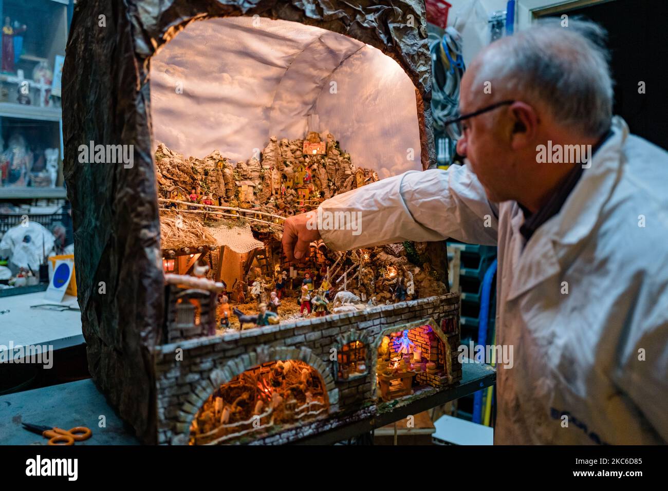 Presepe in costruzione di Giuseppe Magarelli, uno dei più antichi artigiani della Molfetta, nella sua bottega a Molfetta il 24 dicembre 2020. Uno dei più storici artigiani presepi di Molfetta, Giuseppe Magarelli, 68 anni, idraulico, che da 50 anni produce presepi fatti a mano come hobby, membro dell'Associazione Italiana amici della Natività. La sua più grande presepe è lunga 2,20 metri, alta 2,70 metri e profonda 1,70 metri. Ha iniziato a fare presepi con suo padre 50 anni fa e ogni anno, aggiunge o modifica alcune parti, anche facendo tutti i movimenti meccanici ai personaggi. Foto Stock