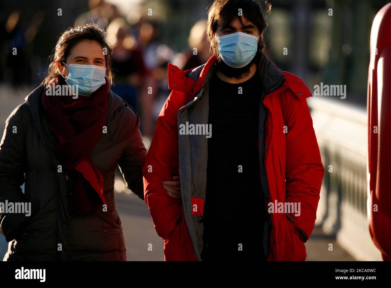Una coppia che indossa maschere facciali attraversa il ponte di Westminster in un clima mite primaverile a Londra, Inghilterra, il 26 febbraio 2021. (Foto di David Cliff/NurPhoto) Foto Stock