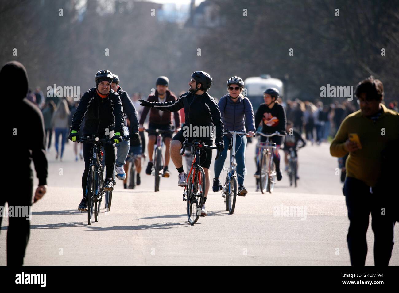 I ciclisti passano attraverso il sole primaverile nei Kensington Gardens di Londra, Inghilterra, il 27 febbraio 2021. (Foto di David Cliff/NurPhoto) Foto Stock