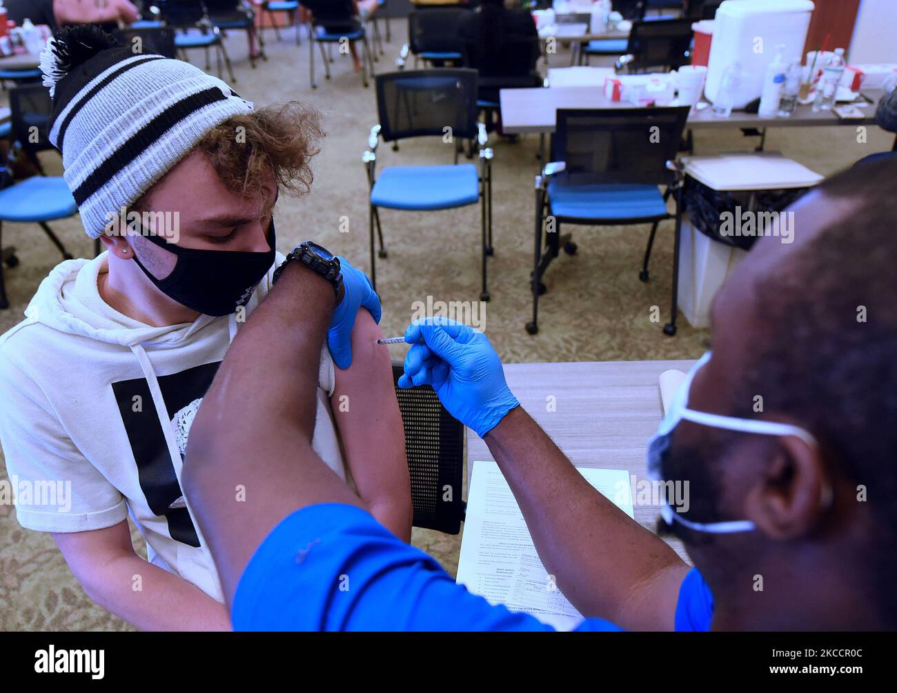 Noah Perez riceve un vaccino Pfizer COVID-19 in un contenitore di vaccinazione per studenti e dipendenti del Lake Sumter state College il 14 aprile 2021 a Clermont, Florida, Stati Uniti. Un giorno prima, il CDC e la US Food and Drug Administration hanno raccomandato agli Stati Uniti di sospendere l'uso del vaccino J&J single shot dopo che sei casi negli Stati Uniti hanno riportato un raro e grave tipo di coagulo di sangue. (Foto di Paul Hennessy/NurPhoto) Foto Stock