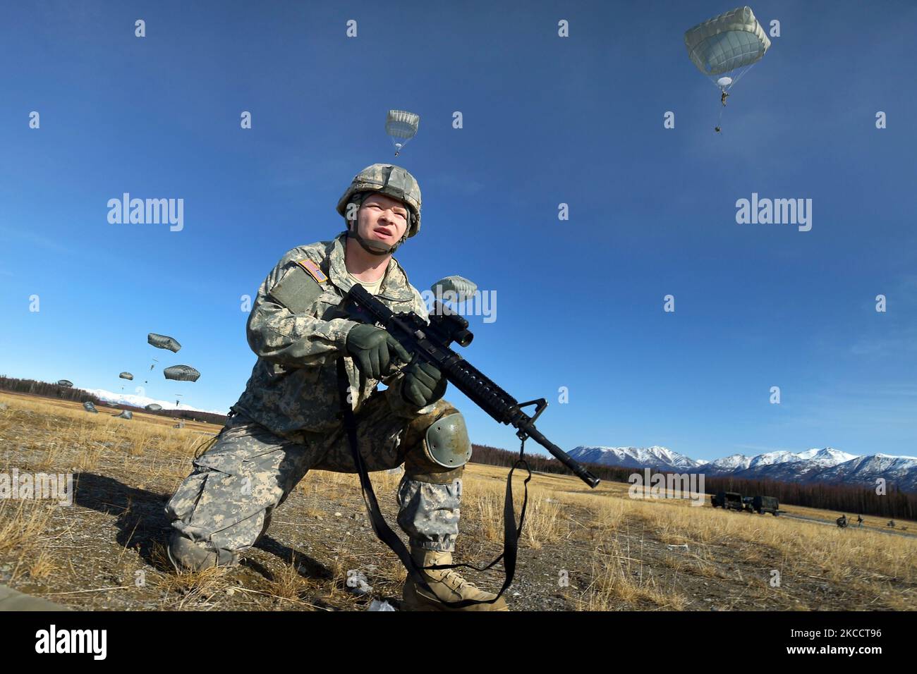 Il soldato dell'esercito degli Stati Uniti tira la sicurezza mentre i paracadutisti conducono un assalto al paracadute. Foto Stock