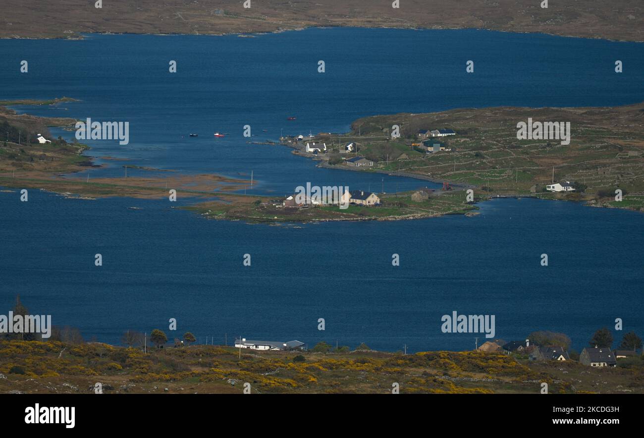 Una vista della baia di Roundstone con una parte dell'isola di Inishnee nel centro visto dalla collina di Errisbeg. Da oggi, l'Irlanda sta allentando alcune restrizioni, tra cui la riapertura di impianti sportivi all'aperto, campi sportivi, campi da golf e da tennis. Le attività sportive senza contatto come il golf e il tennis possono riprendere. Riapriranno anche alcune attrazioni turistiche, tra cui giardini zoologici, fattorie animali aperte e siti storici, ma non parchi divertimenti. Tutti i servizi di ospitalità in queste aree saranno disponibili solo per i servizi da take-away e verranno applicati limiti di capacità. Il governo sta lavorando ai piani per riaprire h Foto Stock