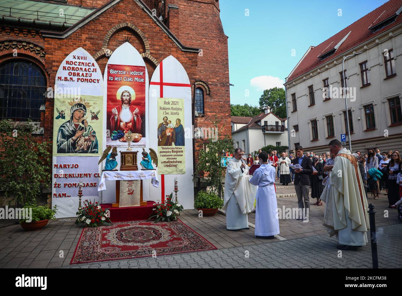 I cattolici celebrano il Corpus Domini partecipando alla Santa Messa e alla processione durante la pandemia del coronavirus. Cracovia, Polonia il 4 giugno 2021. La processione inizia con un sacerdote che porta un mostrania sotto un baldacchino. I fedeli lo seguono cantando inni religiosi, mentre le giovani ragazze vestite con abiti bianchi o tradizionali regionali spargono petali di fiori lungo il percorso. Il Corpus Christi è una festa cattolica mobile che commemora la Transostituzione. (Foto di Beata Zawrzel/NurPhoto) Foto Stock