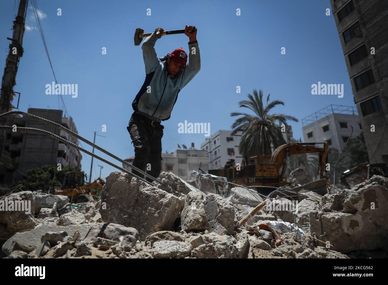 I lavoratori palestinesi e i bulldozer egiziani aiutano il 16 giugno 2021 a rimuovere le macerie delle uildings distrutte dagli attacchi aerei israeliani il mese scorso. - Dopo aver mediato un cessate il fuoco tra israeliani e governanti di Gaza del movimento di Hamas che ha raccolto il peso diplomatico internazionale dell'Egitto, il Cairo sta ora puntando su un progetto di ricostruzione di $500 milioni di dollari per rafforzare la sua influenza politica regionale. Il mese scorso, l'Egitto ha promesso mezzo miliardo di dollari per ricostruire l'enclave palestinese bloccata, che è stata bombardata da Israele per 11 giorni durante pesanti combattimenti con Hamas che si sono conclusi con un intermediario egiziano Foto Stock