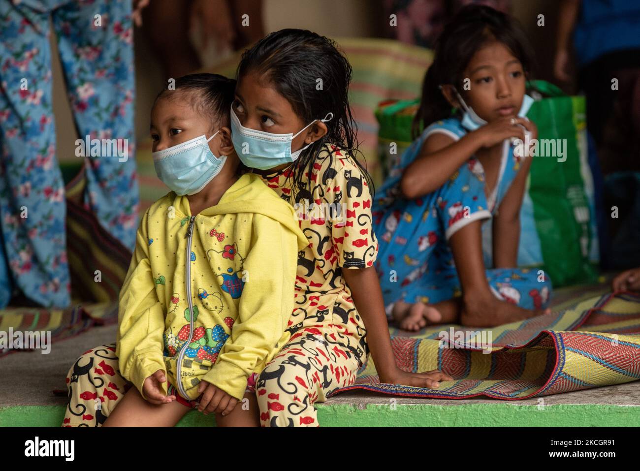 I bambini che indossano maschere facciali come protezione contro COVID-19 cercano un rifugio temporaneo presso una scuola elementare a Laurel, provincia di Batangas, Filippine, il 2 luglio 2021. L'Istituto filippino di Vulcanologia e Seismologia (Phivolcs) ha posto il vulcano Taal sotto livello di allarme 3 a seguito dell'eruzione freatomagmatica ieri, luglio 1 (Foto di Lisa Marie David/NurPhoto) Foto Stock