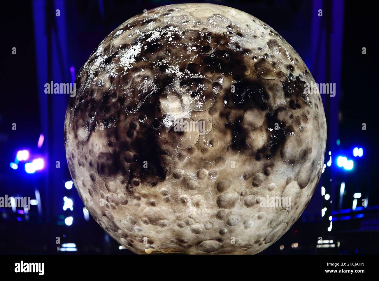 Una signora con una maschera facciale si avvicina ad una proiezione mappata a forma di luna che si vede su un ponte pedonale a New Taipei, in mezzo ad un'epidemia di Covid-19 senza adeguata fornitura di vaccini, a New Taipei, Taiwan, 7 agosto 2021. Si prevede che l’economia del paese riprenderà dopo un focolaio di infezioni multiple e decessi. (Foto di Ceng Shou Yi/NurPhoto) Foto Stock