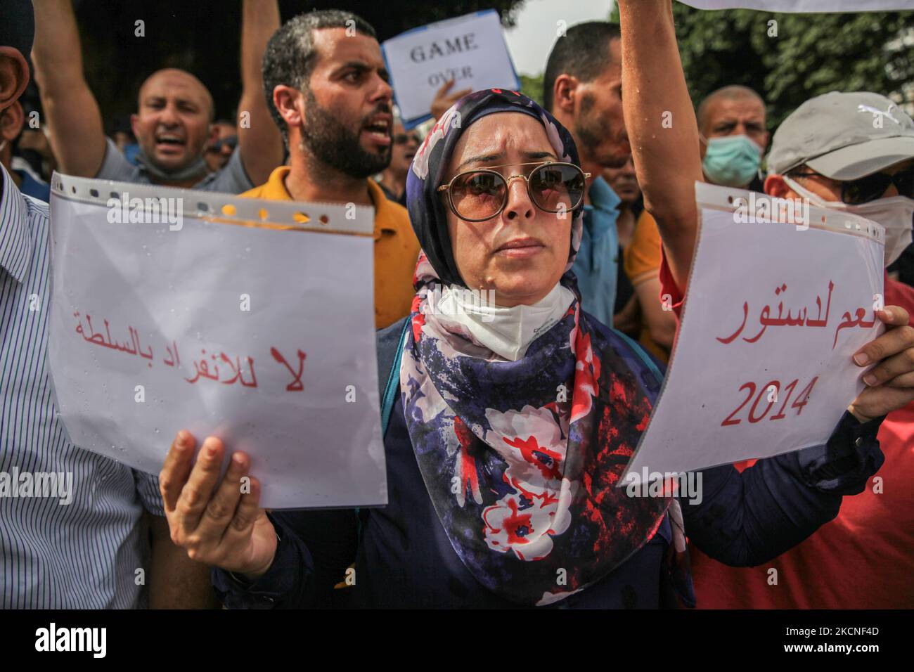 Una donna tiene un cartello che legge in arabo, sì alla costituzione del 2014, no alla regola di un uomo, durante una manifestazione tenutasi su Avenue Habib Bourguiba a Tunisi, in Tunisia, il 26 settembre 2021, per protestare contro ciò che migliaia di manifestanti hanno chiamato un colpo di stato, Riferendosi alle nuove misure eccezionali decretate dal Presidente della Tunisia, Kais Saied e pubblicate sulla Gazzetta ufficiale. Alcuni giorni prima, Kais Saied ha annunciato la continuazione del congelamento del Parlamento e la promulgazione di misure eccezionali per l'esercizio del potere legislativo e di quello esecutivo. Anche lui ann Foto Stock