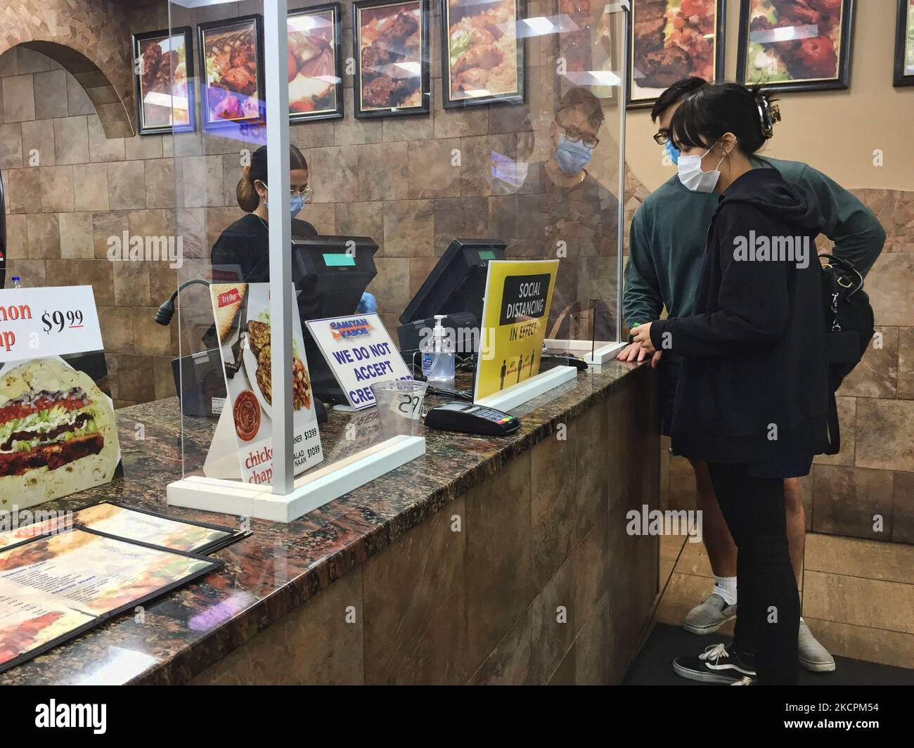 I patroni ordinano il cibo in un ristorante durante la pandemia del nuovo coronavirus (COVID-19) a Toronto, Ontario, Canada il 14 ottobre 2021. Tutti i residenti dell'Ontario che hanno almeno 12 anni sono già tenuti a mostrare una prova di vaccinazione (sotto forma di certificati di vaccino COVID-19) per cenare in ristoranti, nonché visitare palestre, cinema e altri ambienti interni ad alto rischio, tra cui luoghi per eventi sportivi e concerti. I membri del pubblico sono attualmente tenuti a mostrare una copia digitale o cartacea della loro ricevuta del vaccino COVID-19 per dimostrare che sono stati vaccinati completamente, con un vaccino con codice QR migliorato Foto Stock