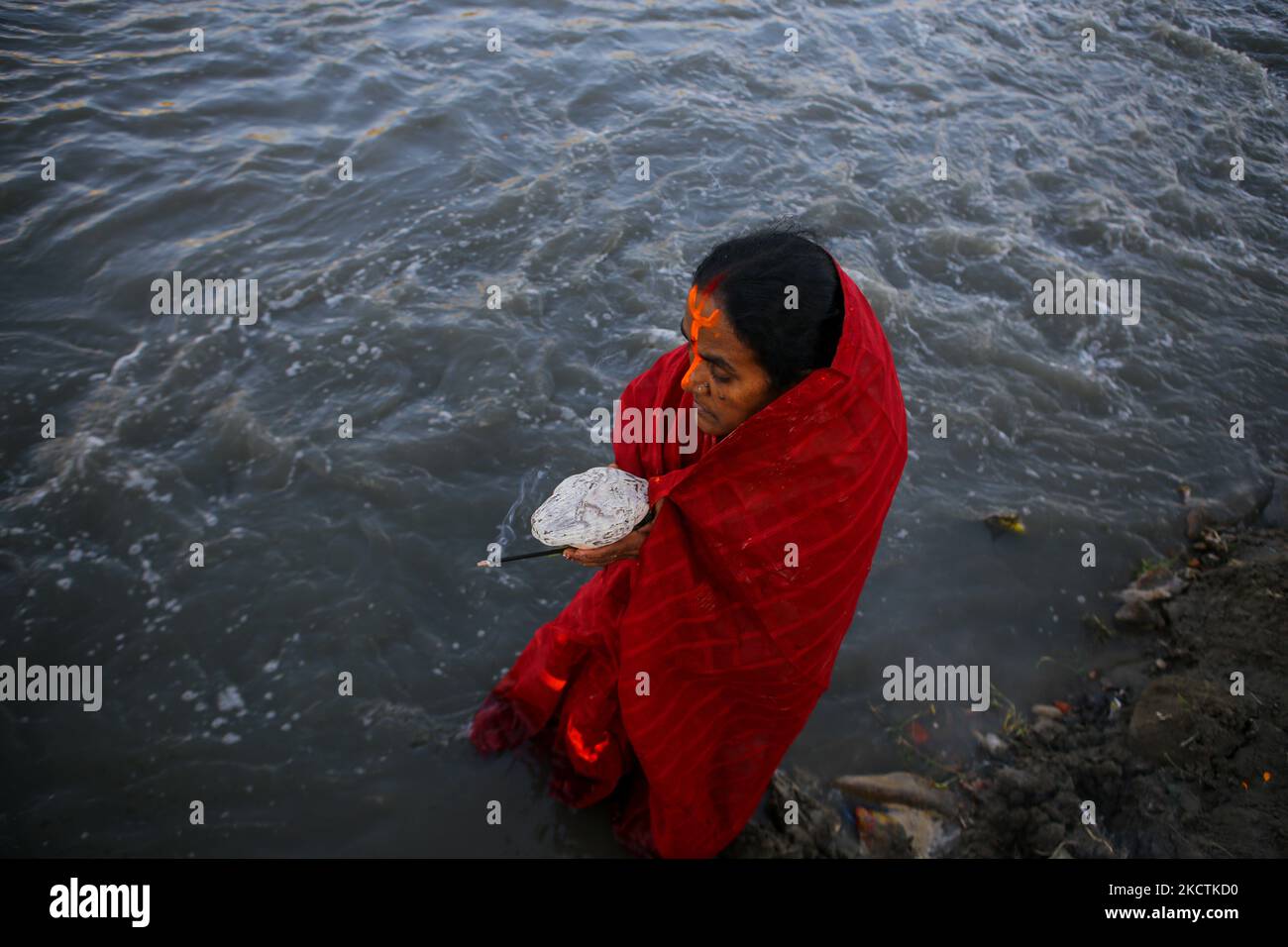 I devoti indù pregano per il sole di impostazione in occasione di Chhath Puja sulle rive del fiume Bagmati a Kathmandu, Nepal il 10 novembre 2021. (Foto di Sunil Pradhan/NurPhoto) Foto Stock