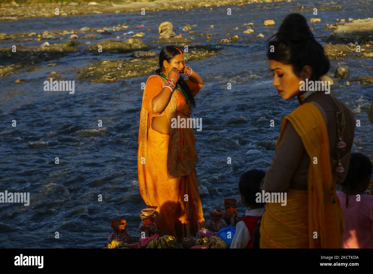 I devoti indù pregano per il sole di impostazione in occasione di Chhath Puja sulle rive del fiume Bagmati a Kathmandu, Nepal il 10 novembre 2021. (Foto di Sunil Pradhan/NurPhoto) Foto Stock